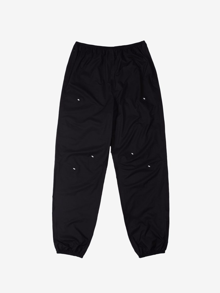 Model wearing Stinger Trouser – Black. Lightweight black technical trousers with articulated knee design.