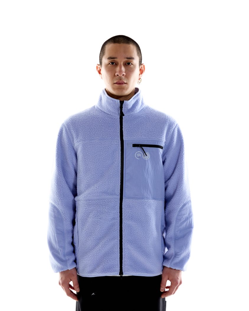 Model wearing Borg Sherpa Fleece – Lilac with high collar and nylon panels. Borg Sherpa Fleece made from recycled fabric with durable construction
