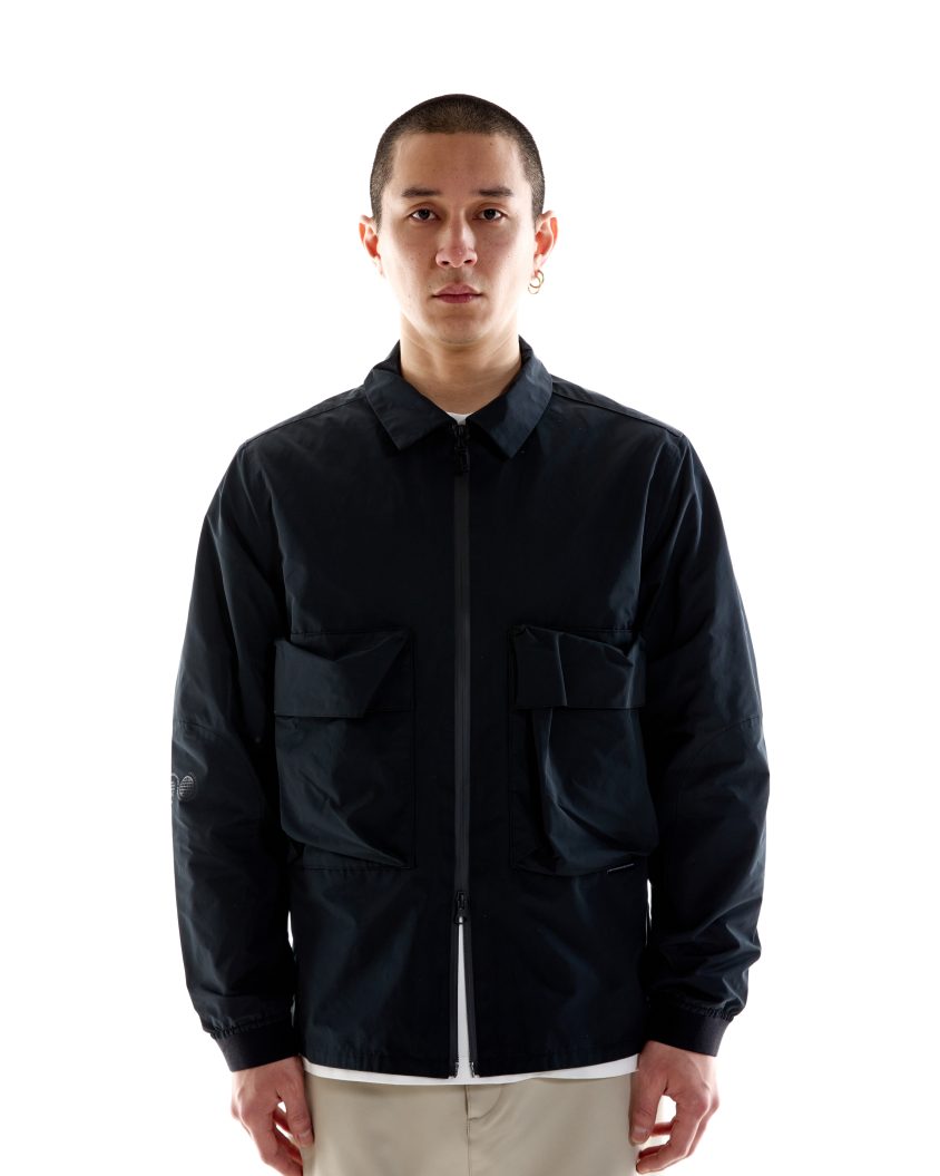 Model wearing Climate Overshirt – Black with structured panel detailing Lightweight, water-resistant overshirt for city and outdoor use