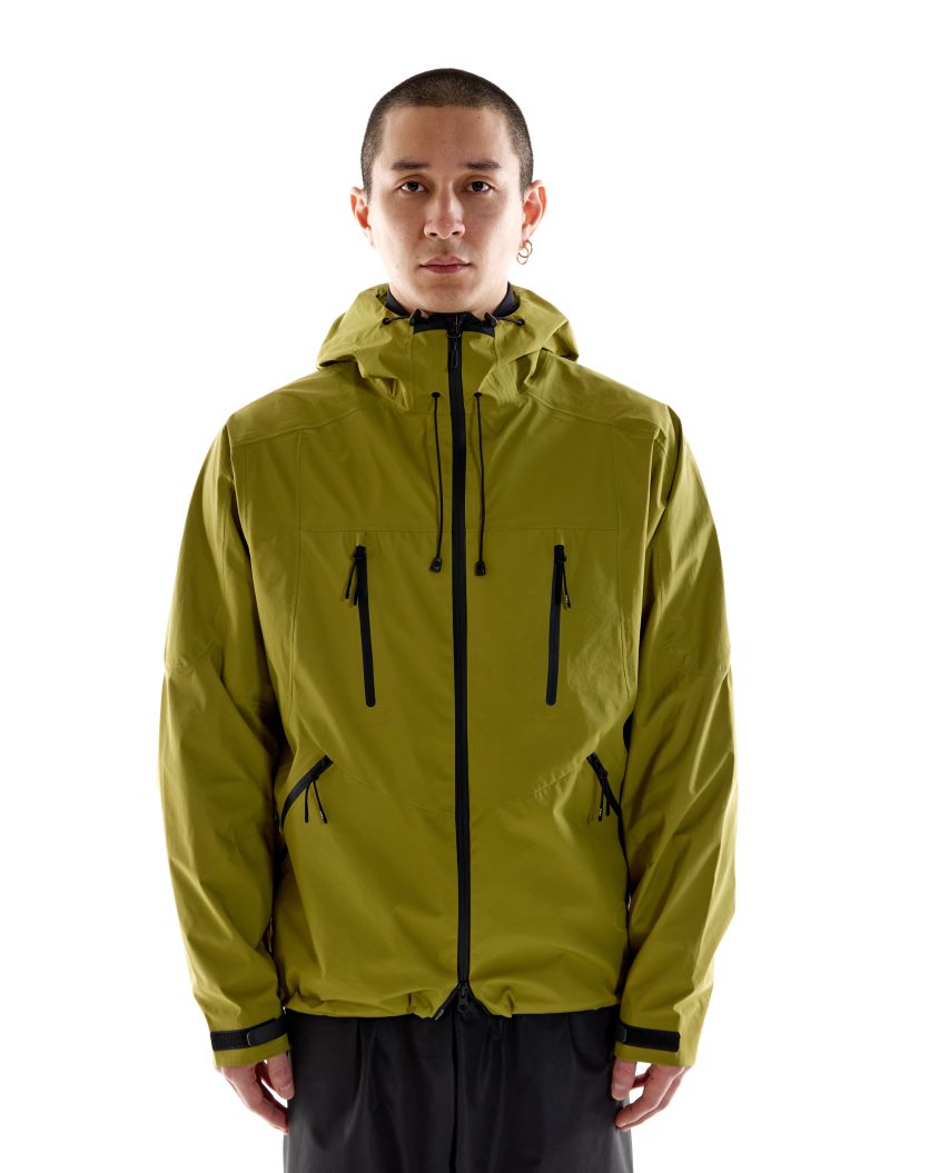 Model wearing 3L Summer Shell – Olive with structured hood and Aquaguard zips Lightweight waterproof jacket with PMO zip pullers and technical features