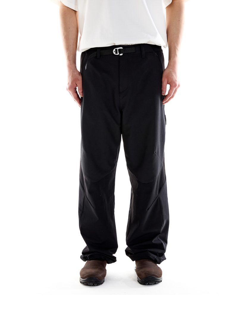 Model wearing Terrain Pant – Black with articulated fit and darted knees, designed for all-weather outdoor use