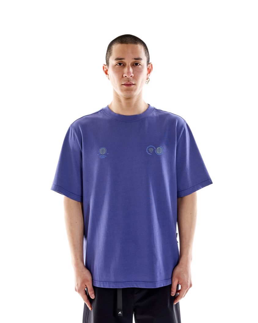 Model wearing White Cotton T-shirt . Globe SS Tee Indigo