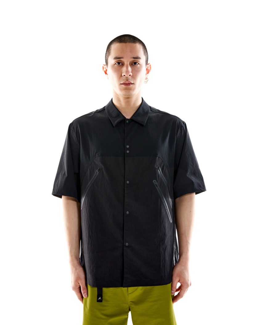 Field Shirt – Black built for outdoor function and urban style. Model wearing Field Shirt – Black with panelled Crinkle-Rip Nylon design.