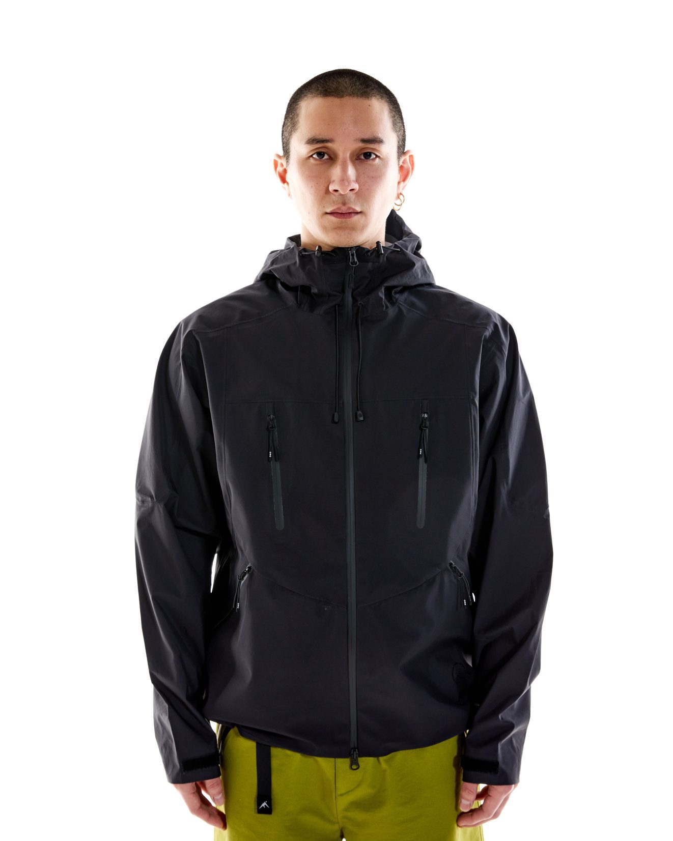 Model wearing 3L Summer Shell – Black with structured hood and Aquaguard zips Lightweight waterproof jacket with PMO zip pullers and technical features
