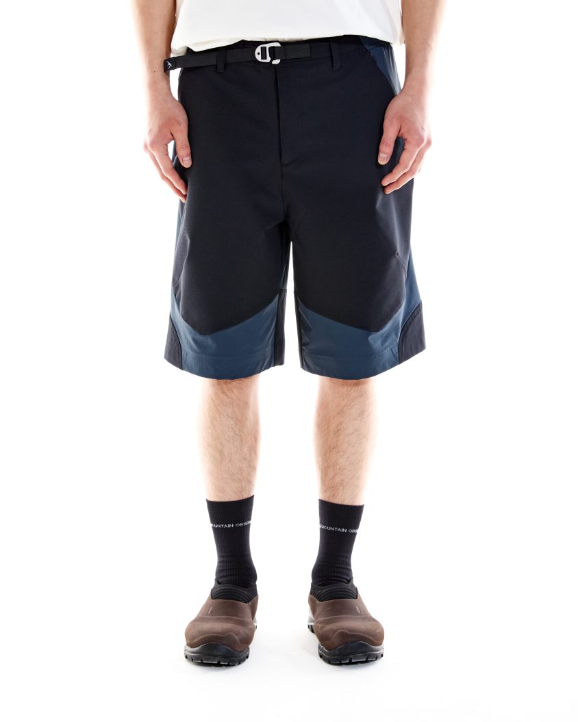 Model wearing Terrain Shorts Airforce Blue with stretch ripstop panels at front and seat. Outdoor-ready shorts designed for movement with breathable, durable construction