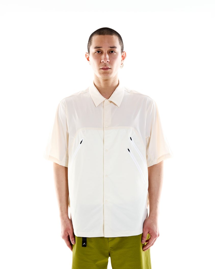Field Shirt – White built for outdoor function and urban style. Model wearing Field Shirt – White with panelled Crinkle-Rip Nylon design.